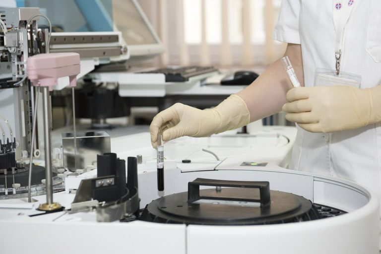 scientist manoeuvring a blood sample