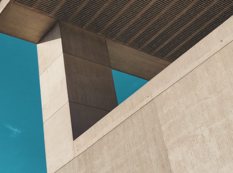 an upward view of a building against a blue sky