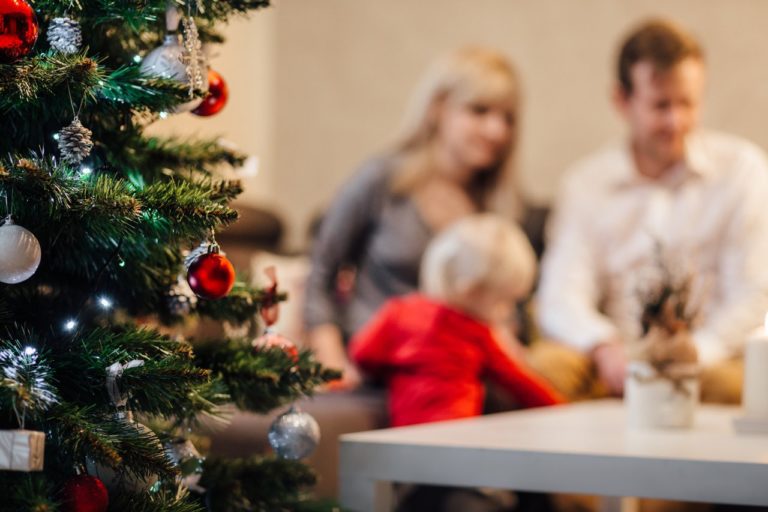 A christmas tree and young family