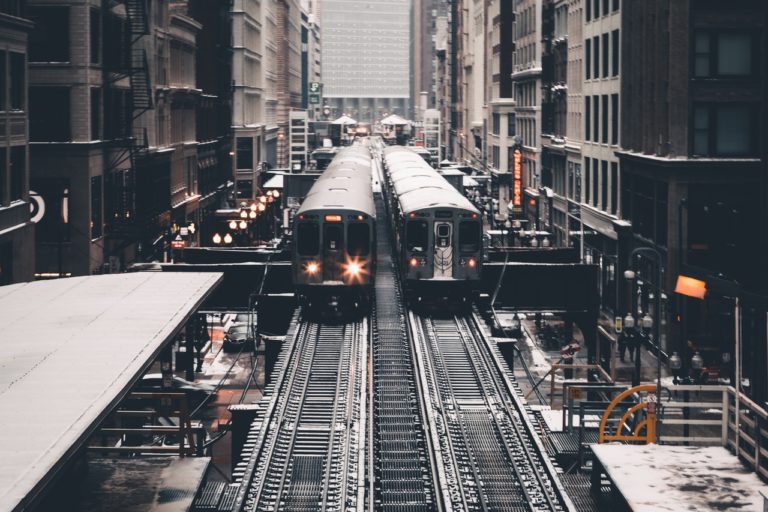 train tracks with two trains next to one another