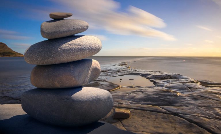 stones staked in a tower on a beach