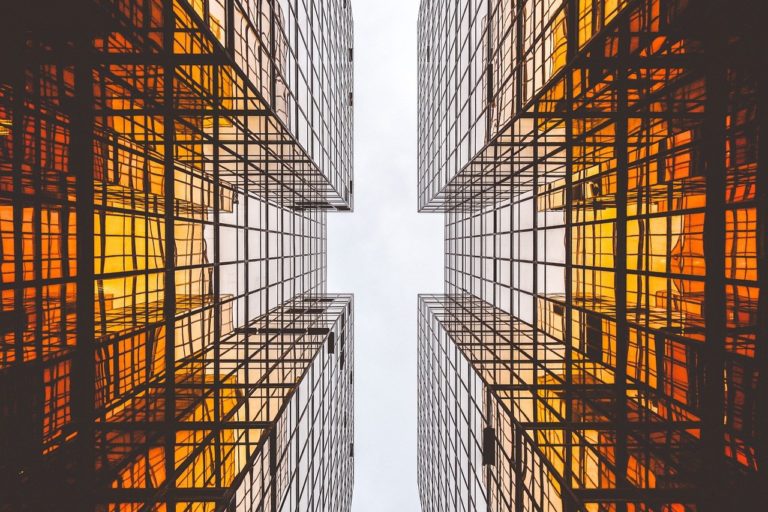 floor taken image of skyscraper buildings looking up at the sky