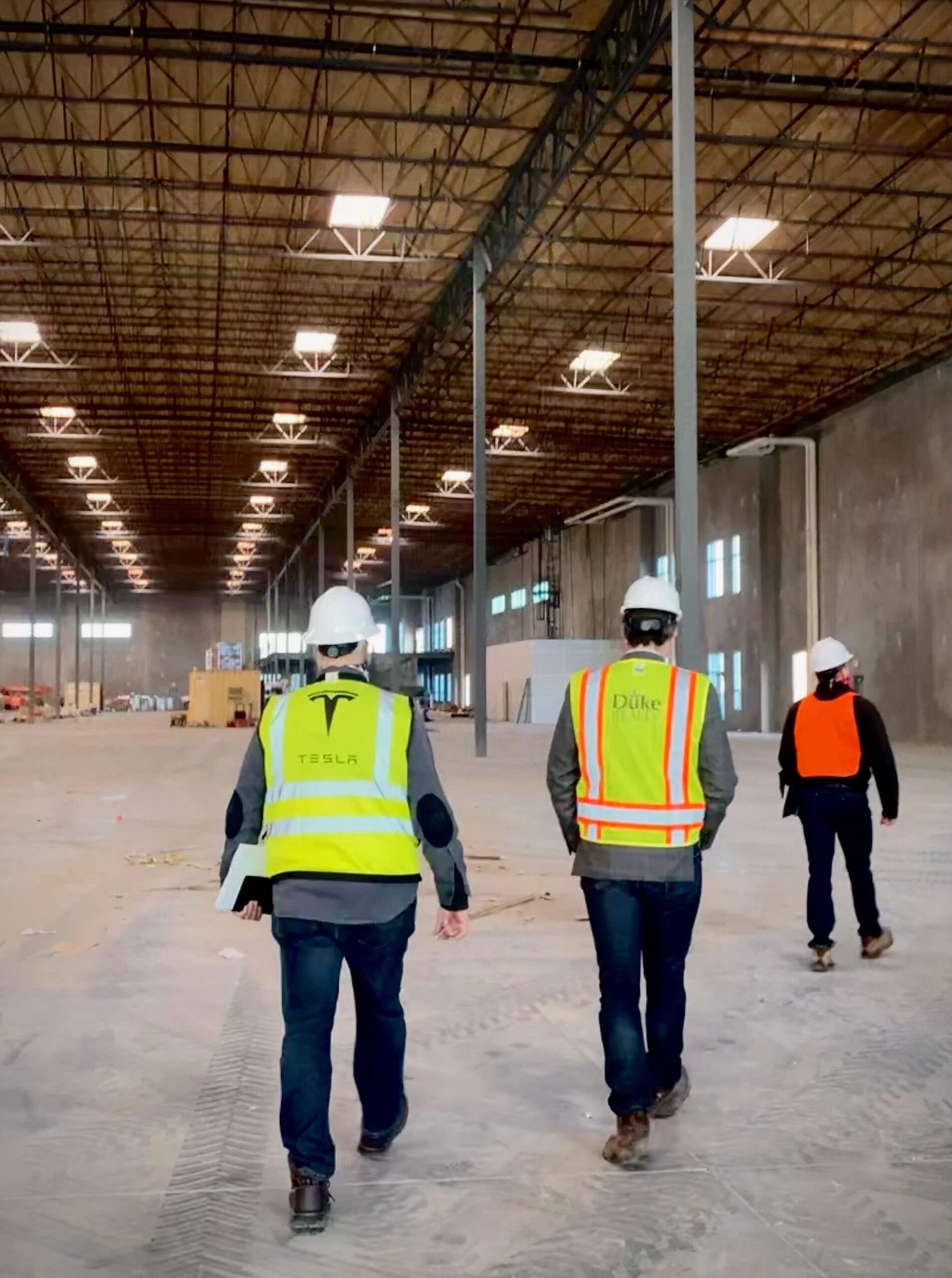 Workers walking inside empty building